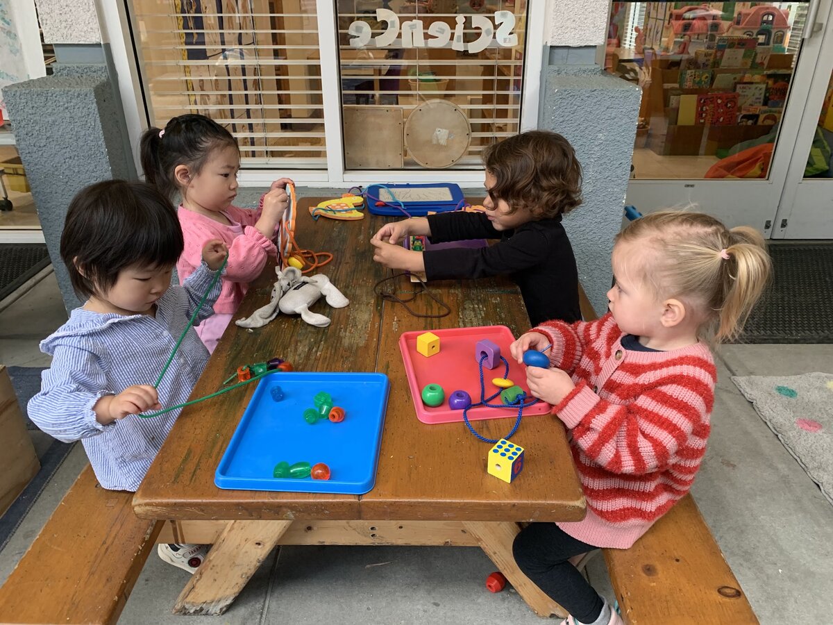Children engaging in group projects and indoor tray activities in the Kangaroo Room